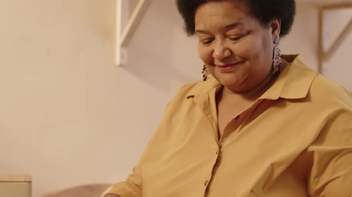 Woman Whisking Eggs in Bright Kitchen