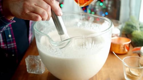Close-Up of Man Whisking Creamy Mixture and Pouring Bourbon for Christmas