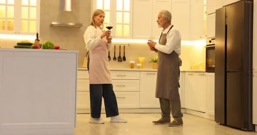 Happy Couple Toasting Wine in Bright Kitchen