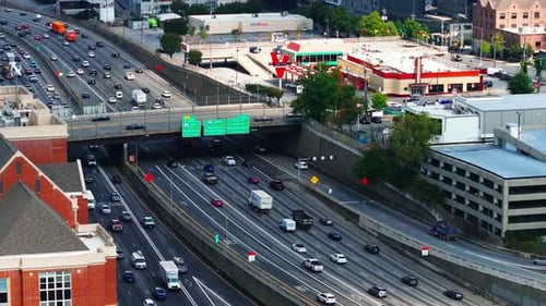 High angle view of heavy traffic on wide highway in city. Vehicles driving in lanes in both directio