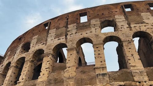 Panning shot of beautiful Amphitheater Architecture in Rome during cloudy day - Colosseum Building I