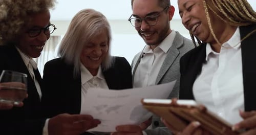 Multiracial business team collaborating on financial strategy inside bank office