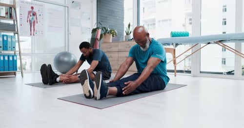 Men Stretching in Physical Therapy Office