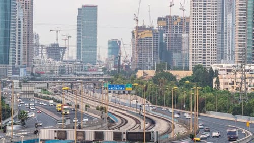Time lapse of cars driving via ayalon road, in front of the cityscape of ramat gan and Tel Aviv citi