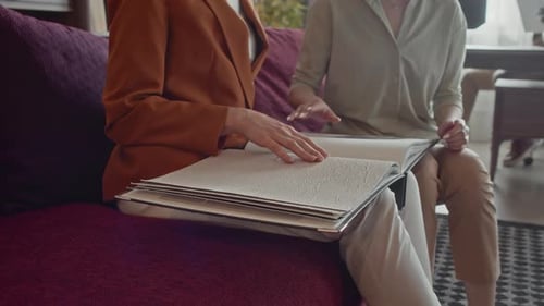 Women Looking Through Furniture Fabric Samples