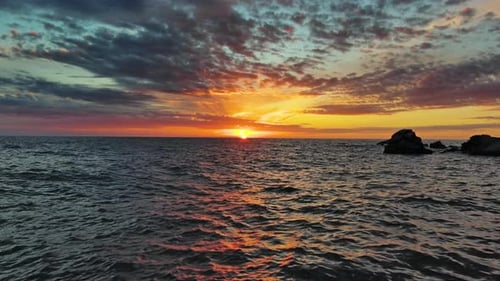 Sea and Rocks During Beautiful Sunset