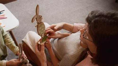 Child and Adult Decorating Easter Bunny Decoration Together