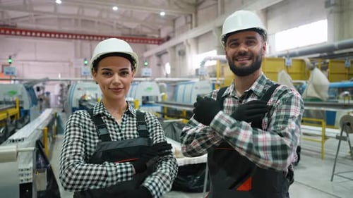 Confident Industrial Workers Smiling at Camera in Factory