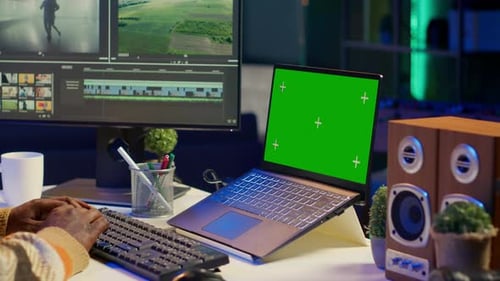 Videographer Creating Visual Effects on Montage Next to Green Screen