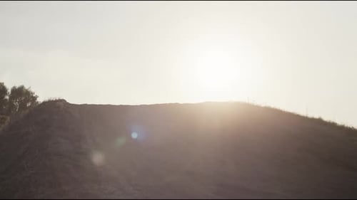 Dirt Bike Rider Jumping on Off-Road Terrain