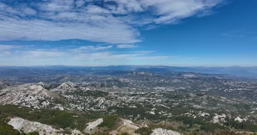 Flying Over The Trees And Revealing The Rocky Mountain Range Of Lovcen In Montenegro. - aerial shot