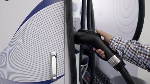 Detailed CloseUp of an Electric Vehicle Charging Station Featuring a Connector for Convenience Media