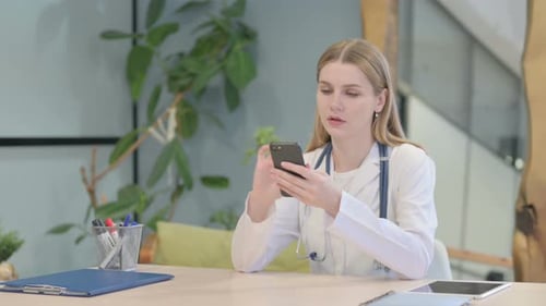 Doctor Browsing Smartphone in Clinic