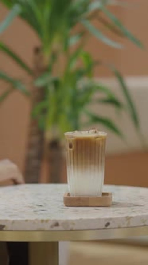 Iced Coffee Sits on a Table in a Cozy Cafe