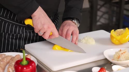 Chef Cuts Yellow Pepper with Sharp Knife
