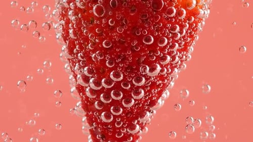 Strawberry Sinking in Sparkling Water with Bubbles