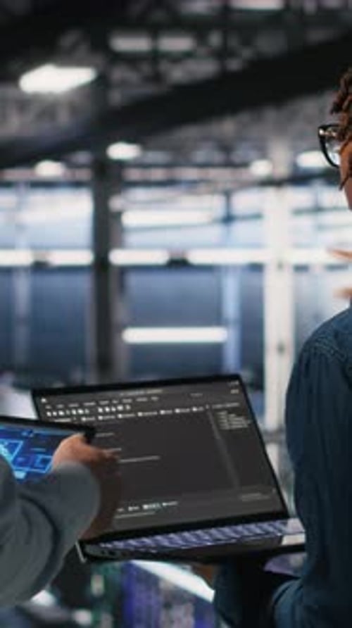 Vertical Video Data Center System Administrators Performing Maintenance on AI Supercomputers