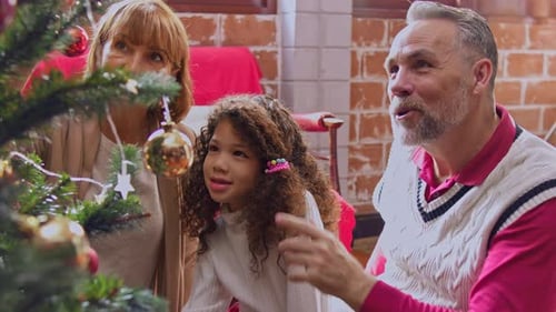 Family Decorates Christmas Tree with Love and Joy