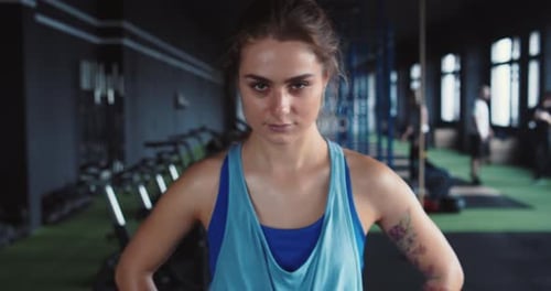 Confident Young Woman Posing After Workout in Gym