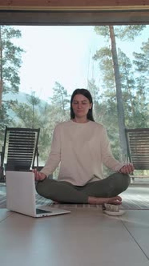 Woman Practicing Yoga with Online Lesson in Modern Minimalist House