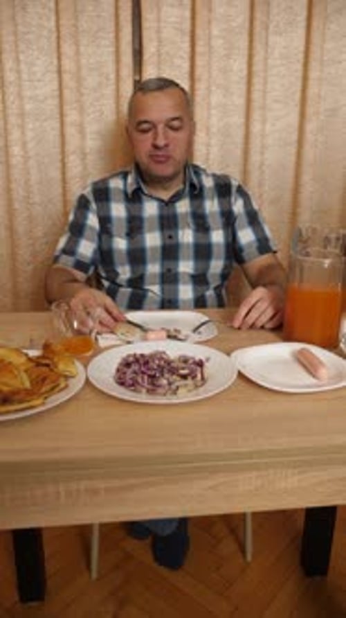 Adult Man Eating Lunch at the Table Indoors