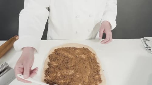 Rolling Dough with a French Rolling Pin to Bake Cinnamon Rolls