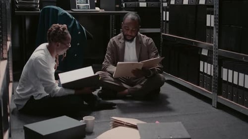 Adults Reviewing Files in Storage Room