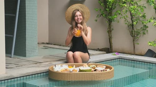 Woman Relax on Tropical Villa with Floating Breakfast in Swimming Pool