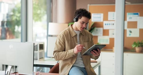 Young Man Using Tablet in Modern Office Setting