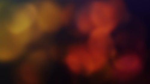Glamour Collection: Orangish golden bokeh swirling over a dark colored background
