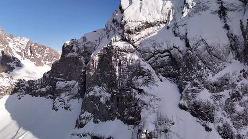 Breathtaking Aerial View of Massive Snow Covered Rugged Mountain Peaks