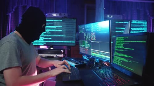 Hacker Typing Code in Dark Room