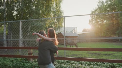 Romantic Outdoor Moment Captured in Warm Sunset Glow Serene Farm Setting Featuring Loving Couple