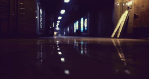 Dimly Lit Corridor with Reflections in a Building at Night