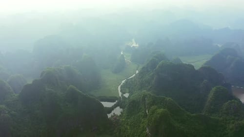 Drone, landscape and river in mountains with fog in the sky of jungle, nature