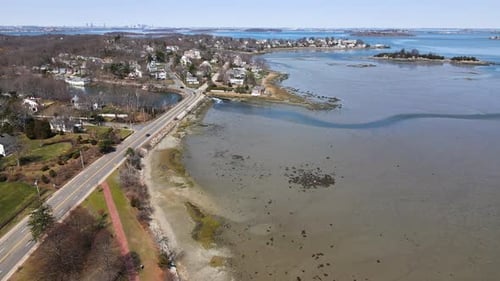 Aerial footage of mudflats at Hingham MA with Boston Cityscape in distance