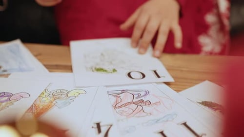 Little Girl Draw a Picture for Santa in New Year in the Room