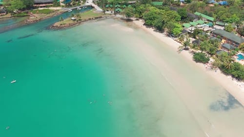 Tropical Beach Resort with Turquoise Water and Lush Vegetation