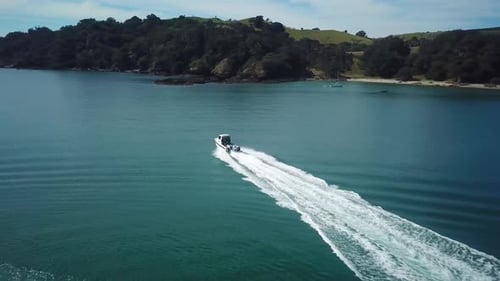 aerial, following a speed boat from behind while the boat is travelling towards the ocean. 4K