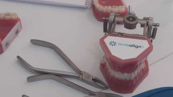Invisalign demonstration model with orthodontic tools on dental table ...