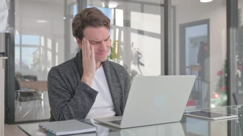 Man Working on Laptop, Experiencing Headache