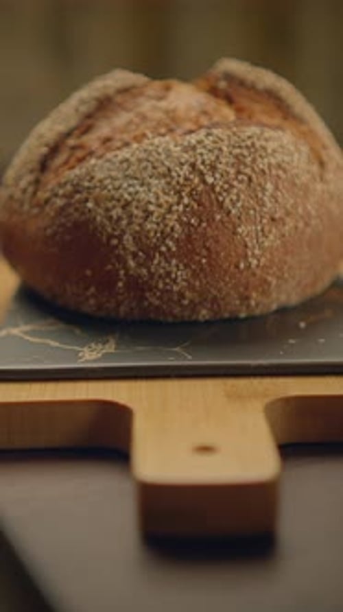 Delicious Artisan Rustic Bread Displayed on a Beautiful Wooden Board for Serving or Enjoyment
