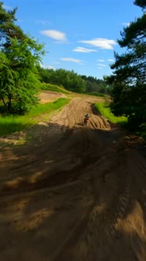 Motocross Bike Riding on Dirt Trail in Nature