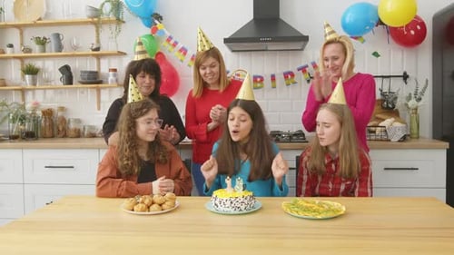 Friends Celebrate Birthday with Cake and Balloons
