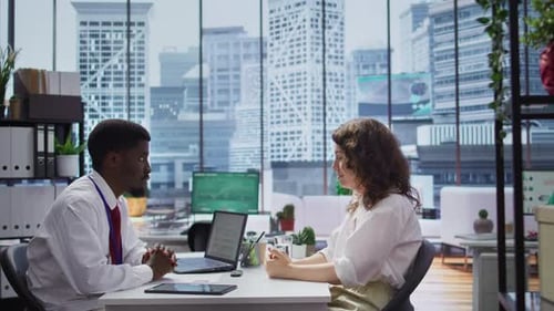 African American Interviewer Discussing with Candidate About Company Objectives