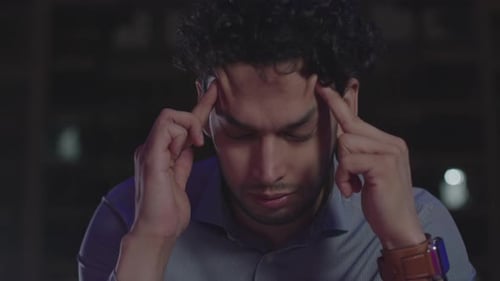 Workaholic businessman entrepreneur burnout at work late night feeling tired and exhausted, making h