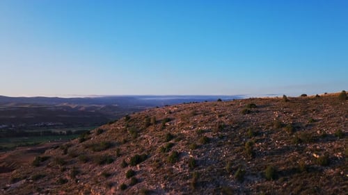 Reveal drone shot over mountain of landscape during sunrise