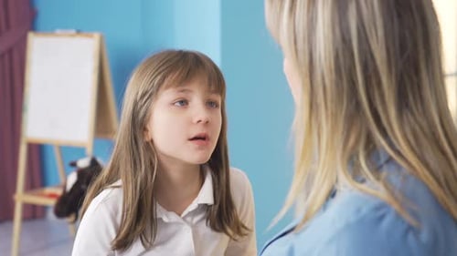 Child Talking with an Adult Woman Indoors