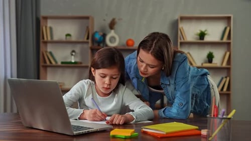 Young Child Girl Studying at Home Small Girl Sits at Desk and Attends School Class Online on Laptop