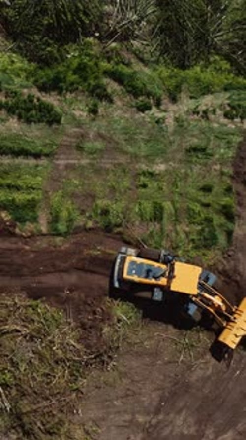 Bulldozer working on field. Top down view of excavator machine on field
